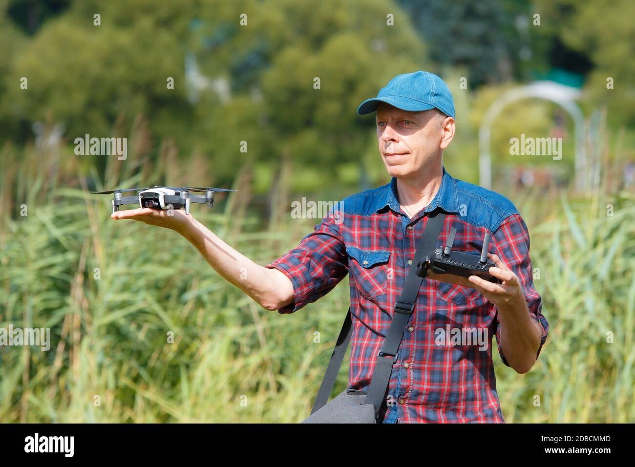 A man launches a drone from his hand. A man holds a drone on his outstretched arm Stock Photo