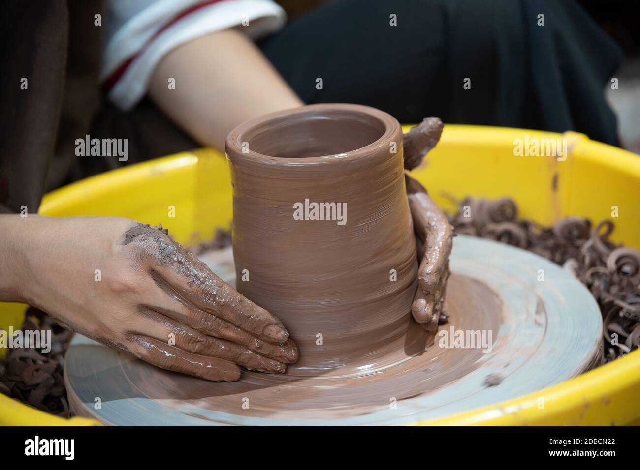 A selective focus shot of a person doing a traditional pottery making Stock Photo