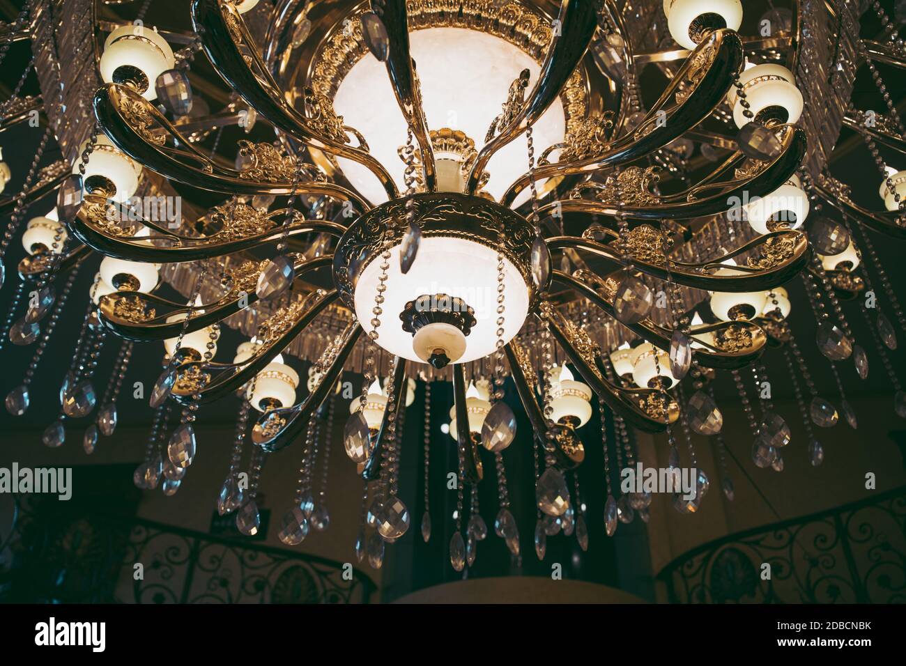 A low angle view of a fancy Chandelier with the lights on with a blurry background Stock Photo