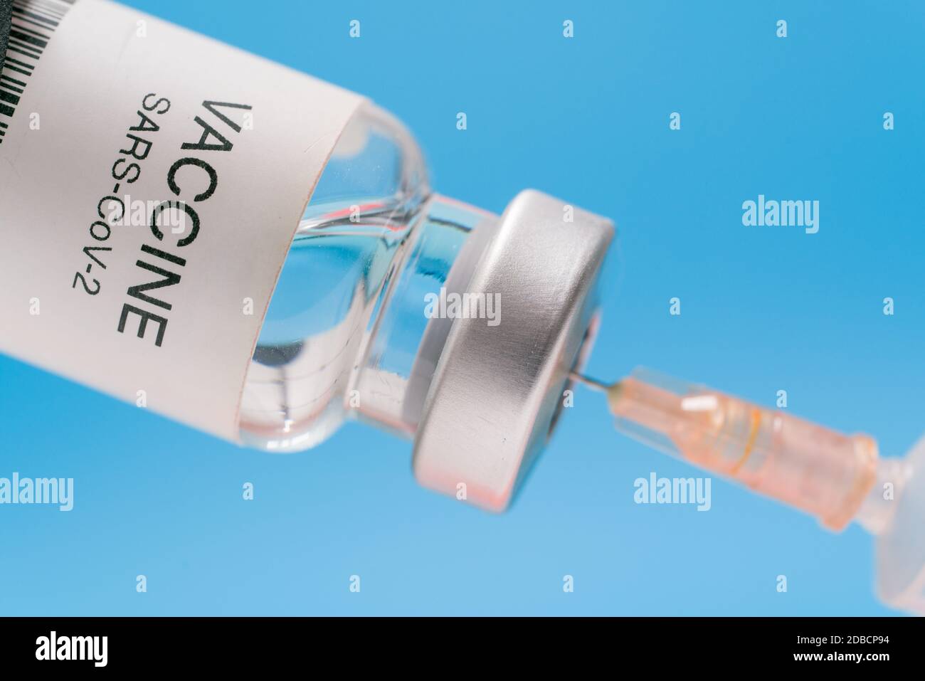 Vaccine vial with syringe isolated over blue background. Medical ...