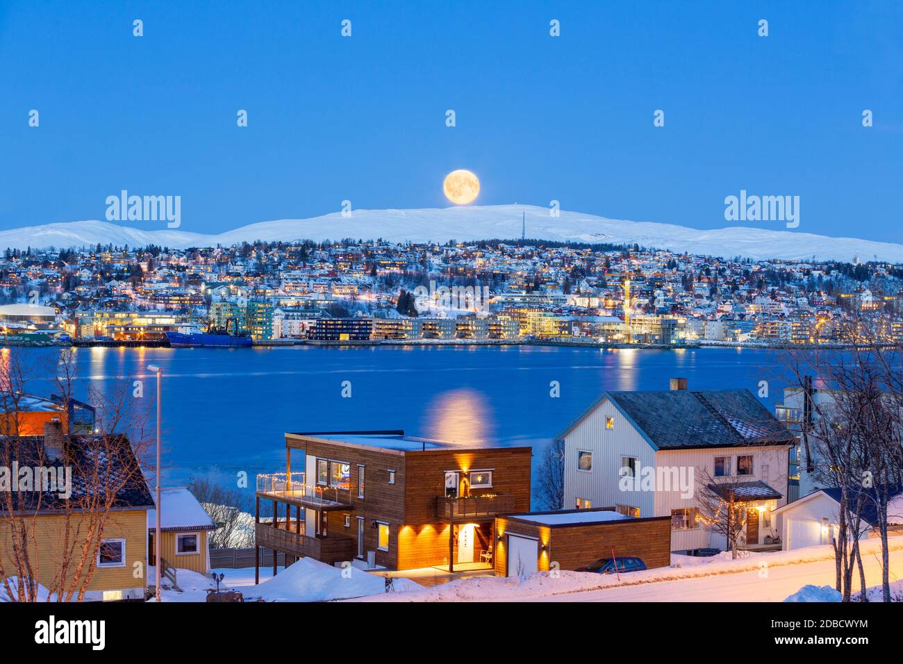 Tromso City At Full Moon In Winter Time, Christmas in Tromso, Norway Stock Photo