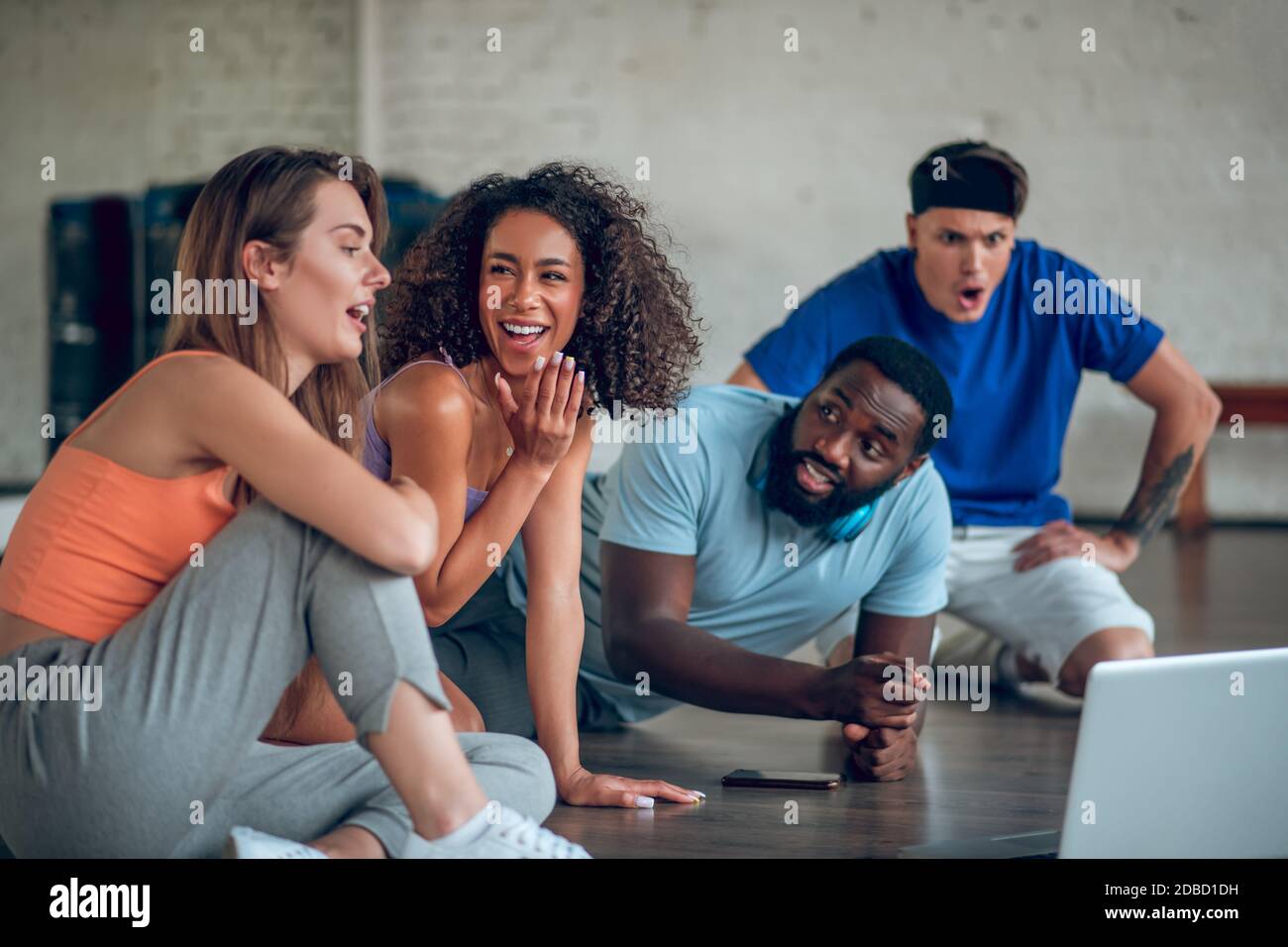 Colleagues discussing foreign dance videos from internet Stock Photo