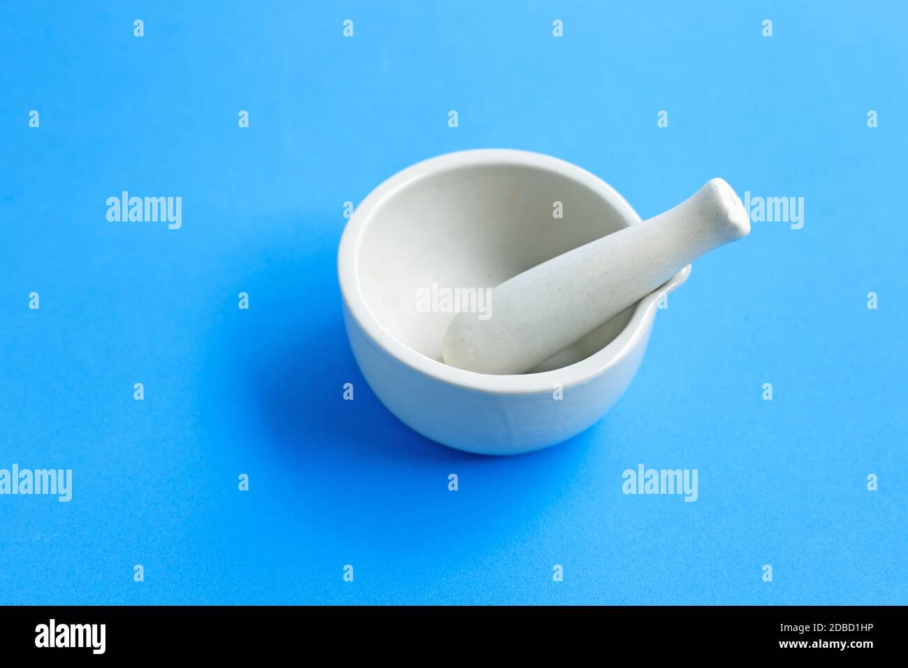 Mortar and pestle on blue background. Copy space Stock Photo Alamy