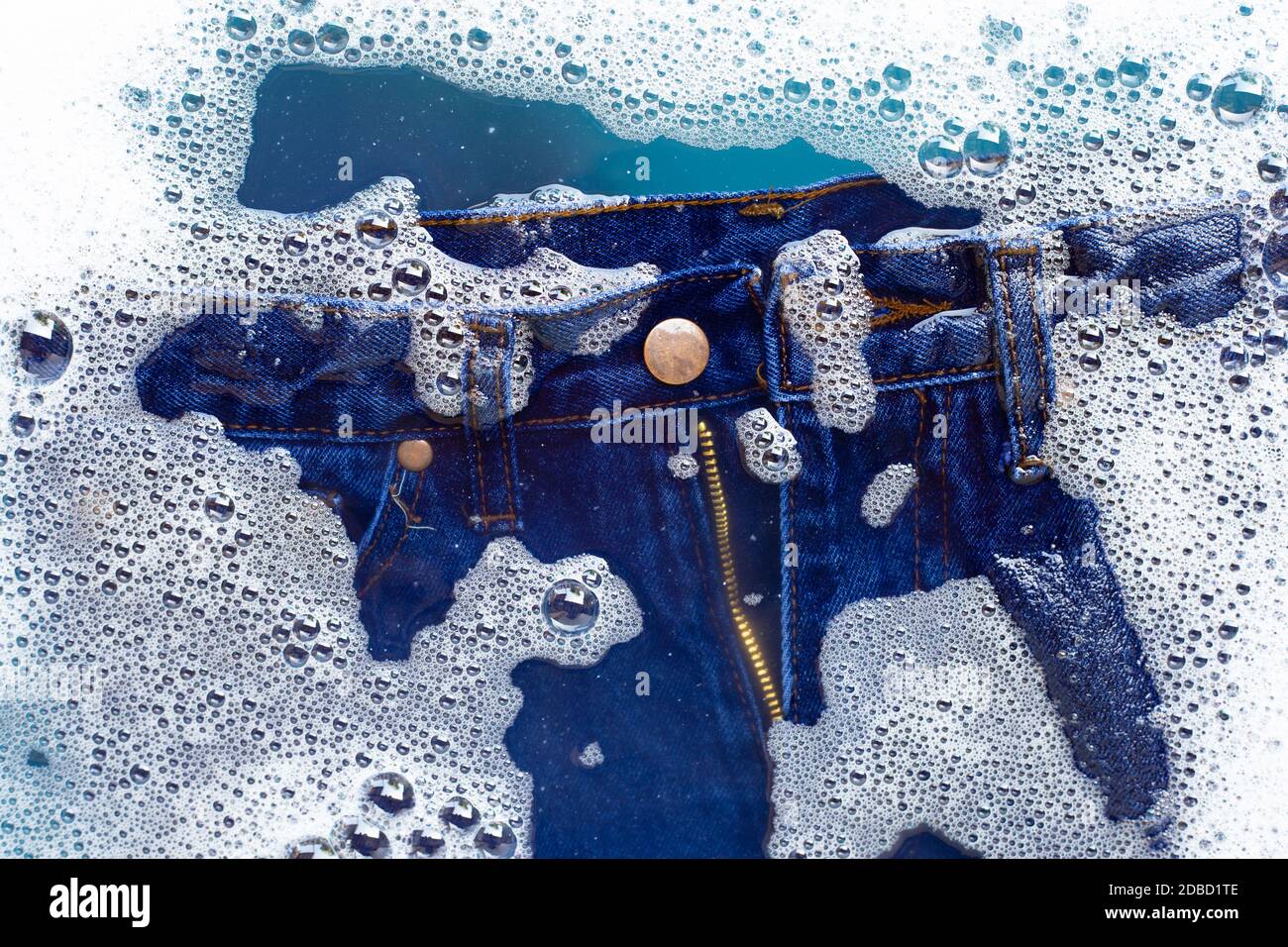 Jeans soak in powder detergent water dissolution, washing cloth