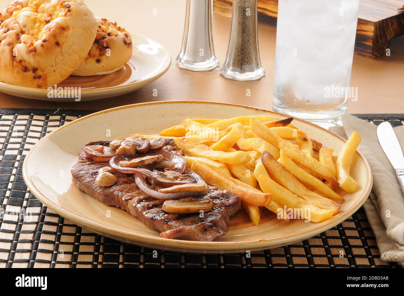 A grilled steak with sauteed mushrooms and onions Stock Photo - Alamy
