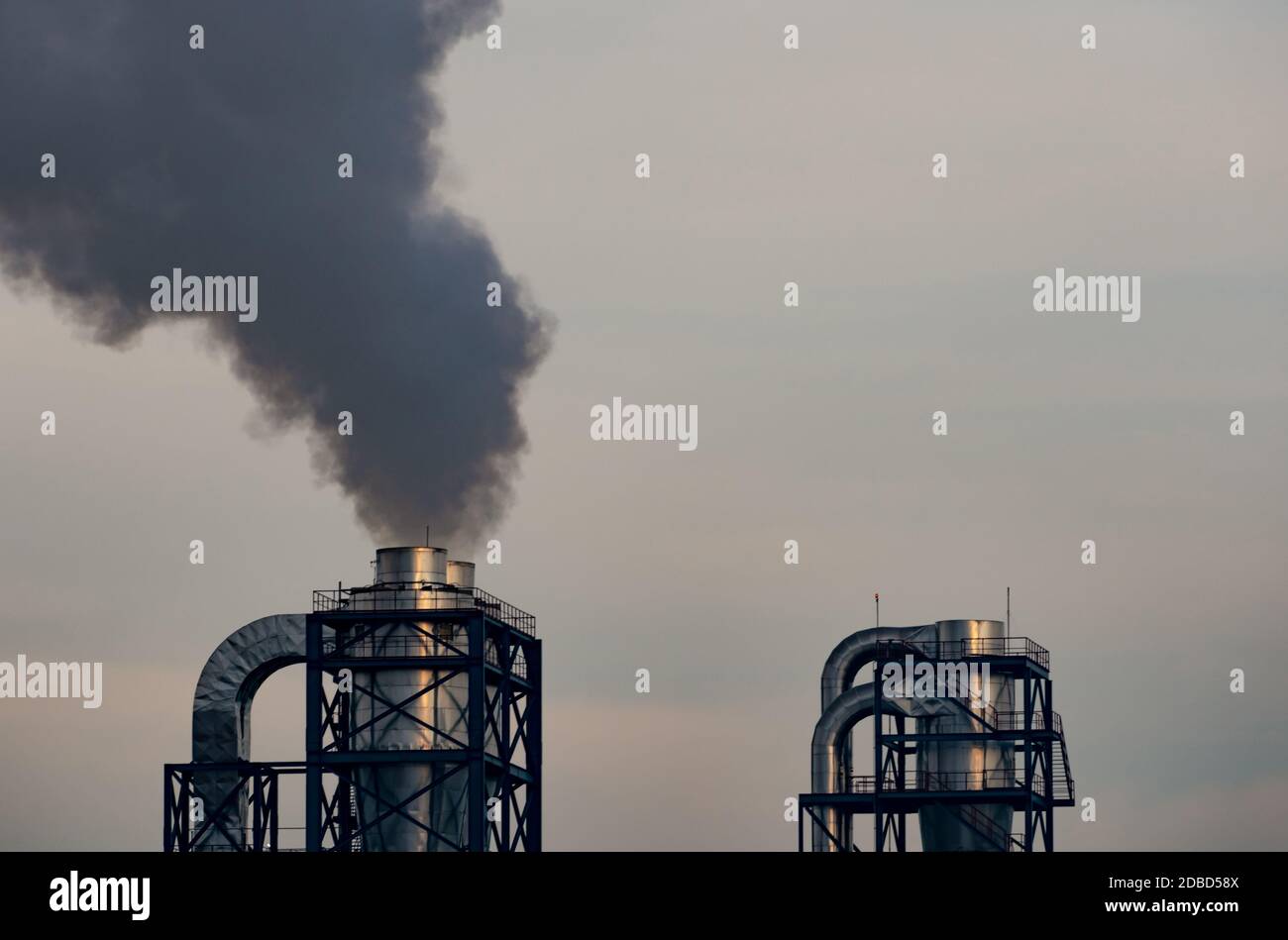 Air pollution from factory. Black smoke from chimney of industrial pipe. Global warming problem