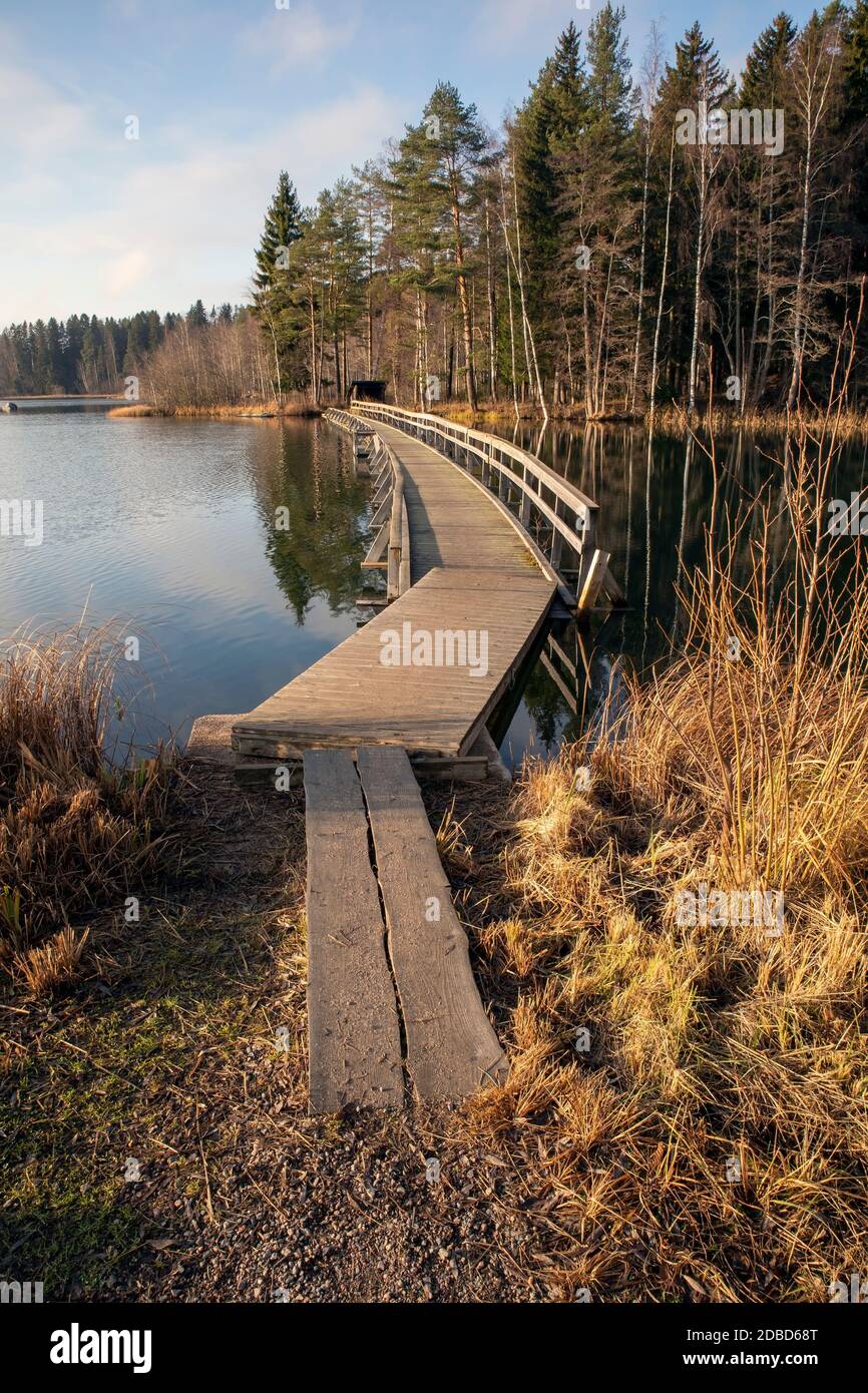 Wooden bridge pathway over water surface in Mellonlahti, Imatra Finland Stock Photo