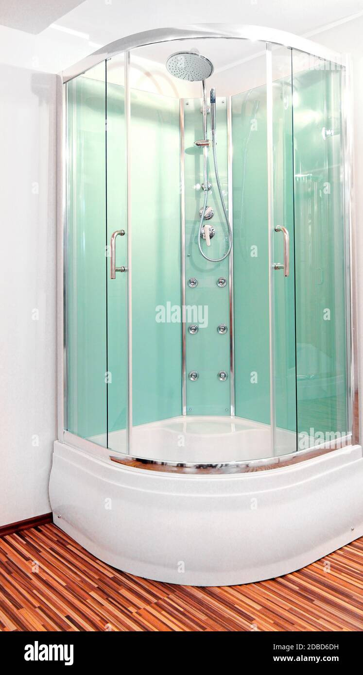 Shower cabin with green glass doors in corner Stock Photo - Alamy