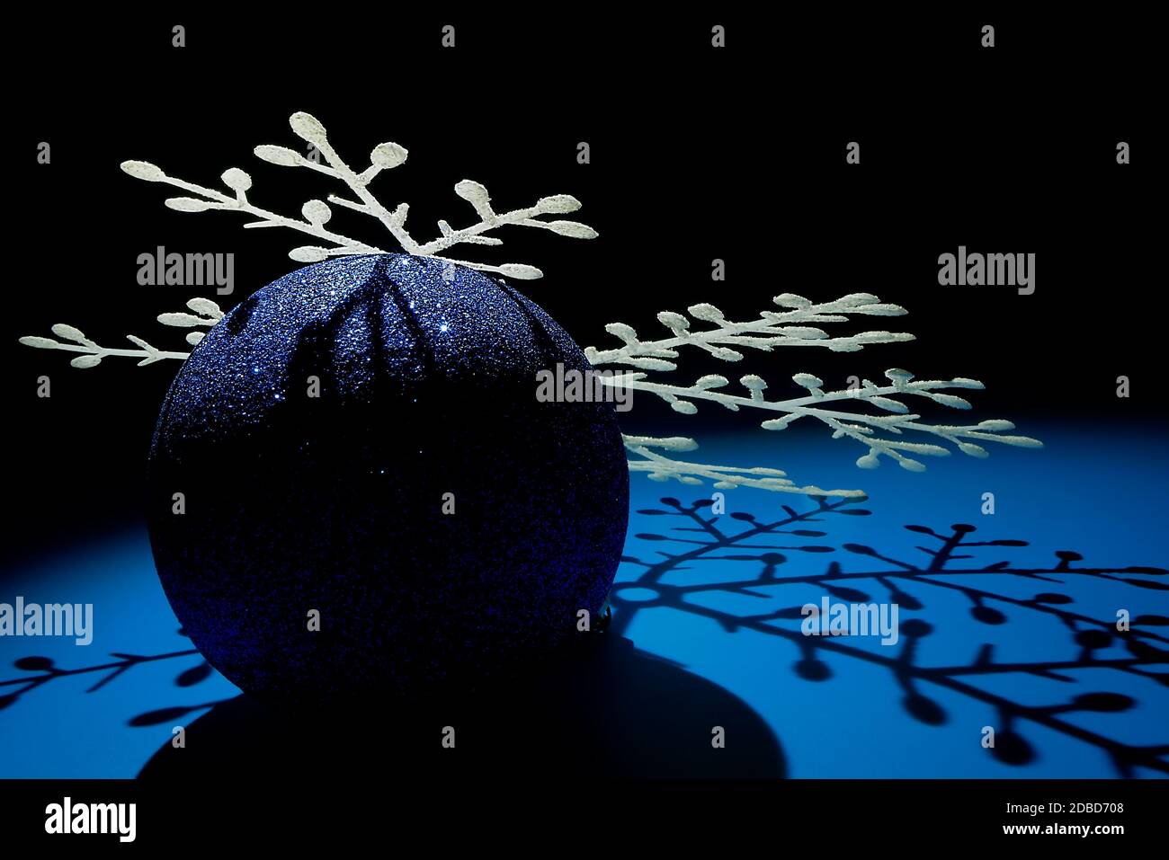 Christmas composition made of shiny blue ball and white snowflake ...