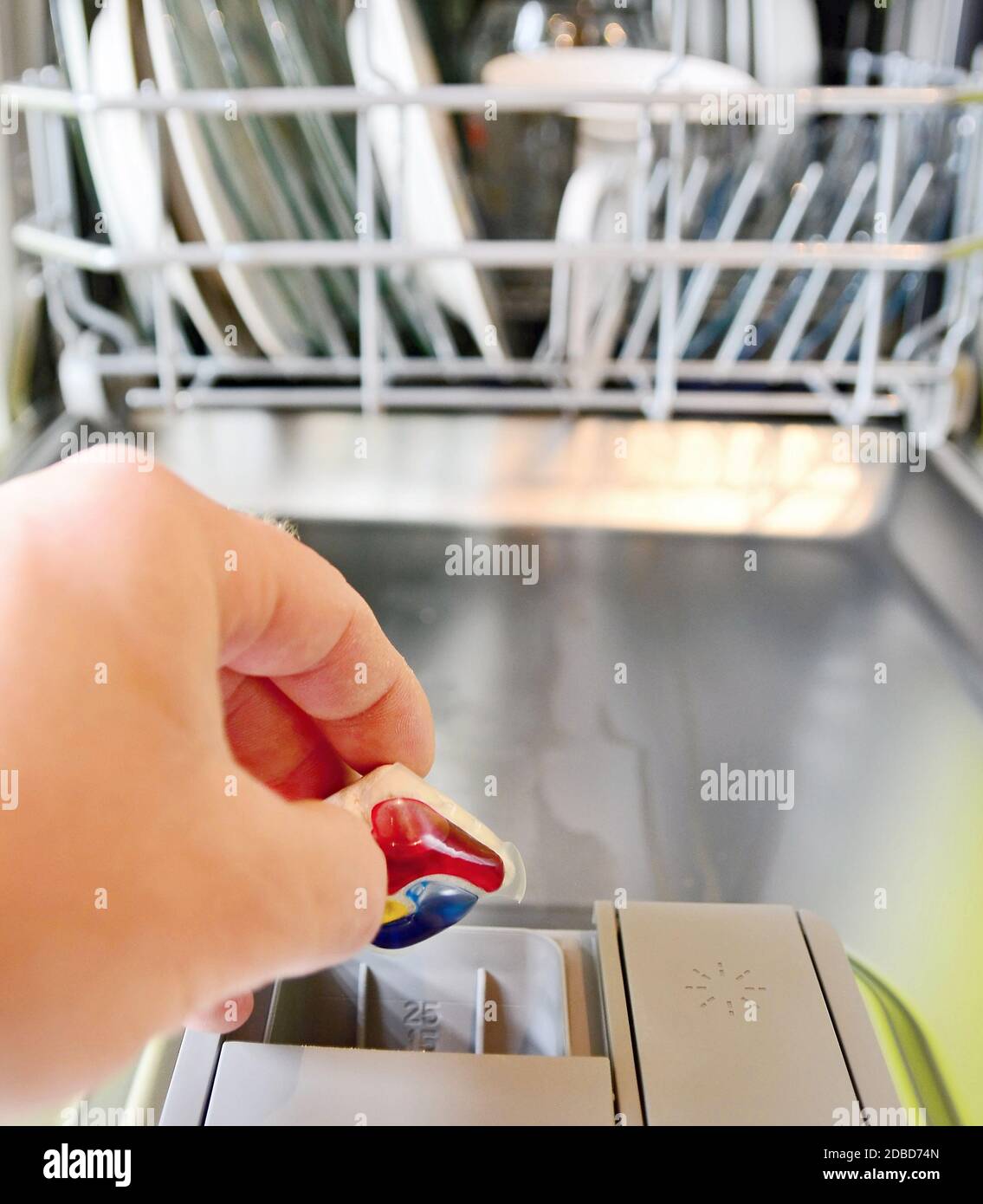 Closeup of hand holding and put detergent clean tablet into a dishwasher tray Stock Photo Alamy