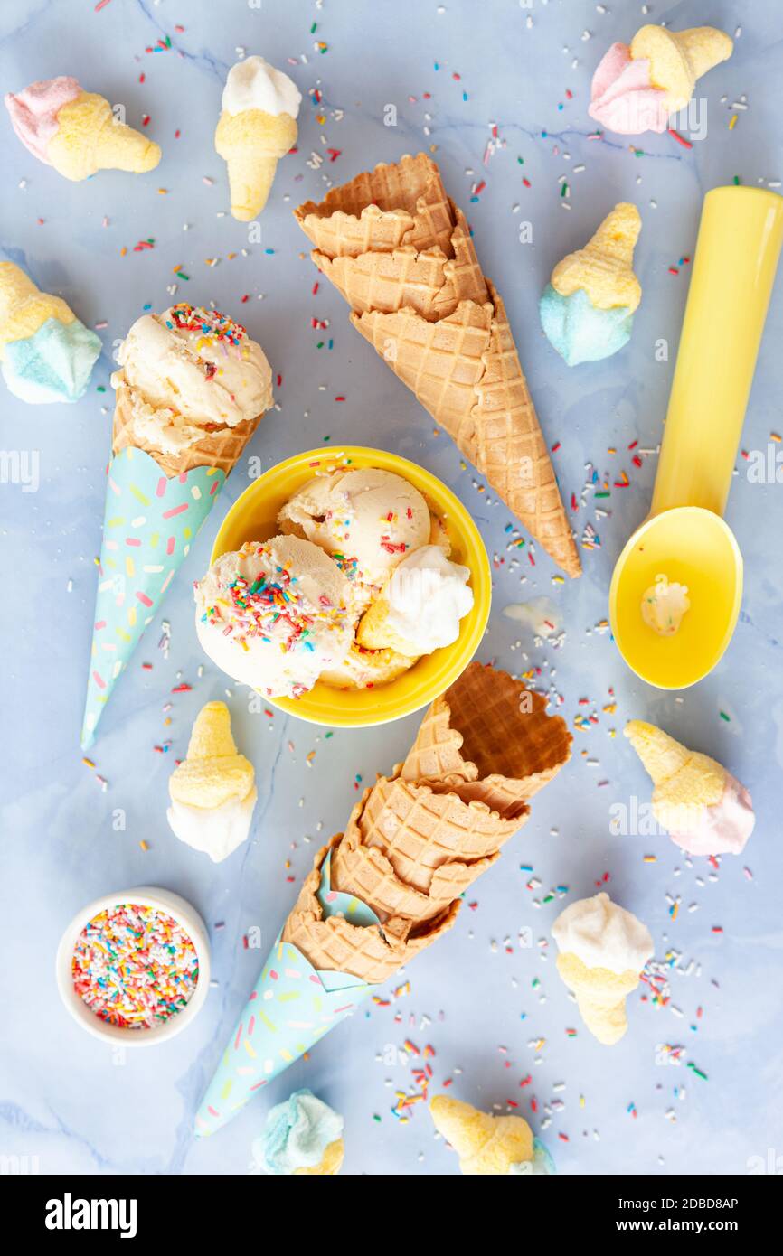 Scoops of vanilla ice cream with rainbow sprinkles Stock Photo Alamy