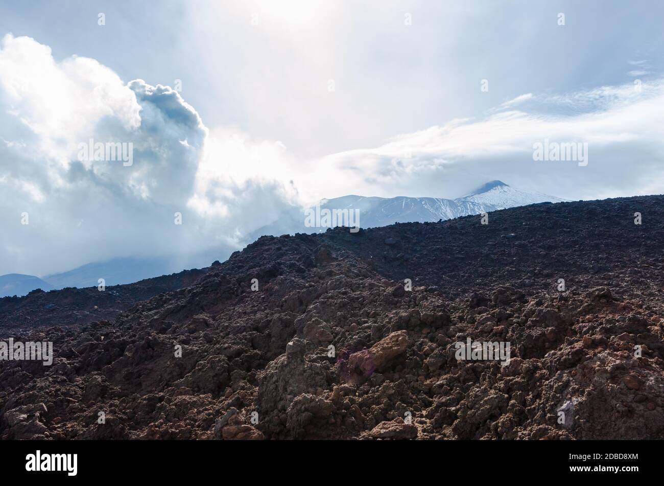 Clouds og volcanic smoke passing over Mount Etna slopes and hills in Sicily, Italy. Stock Photo