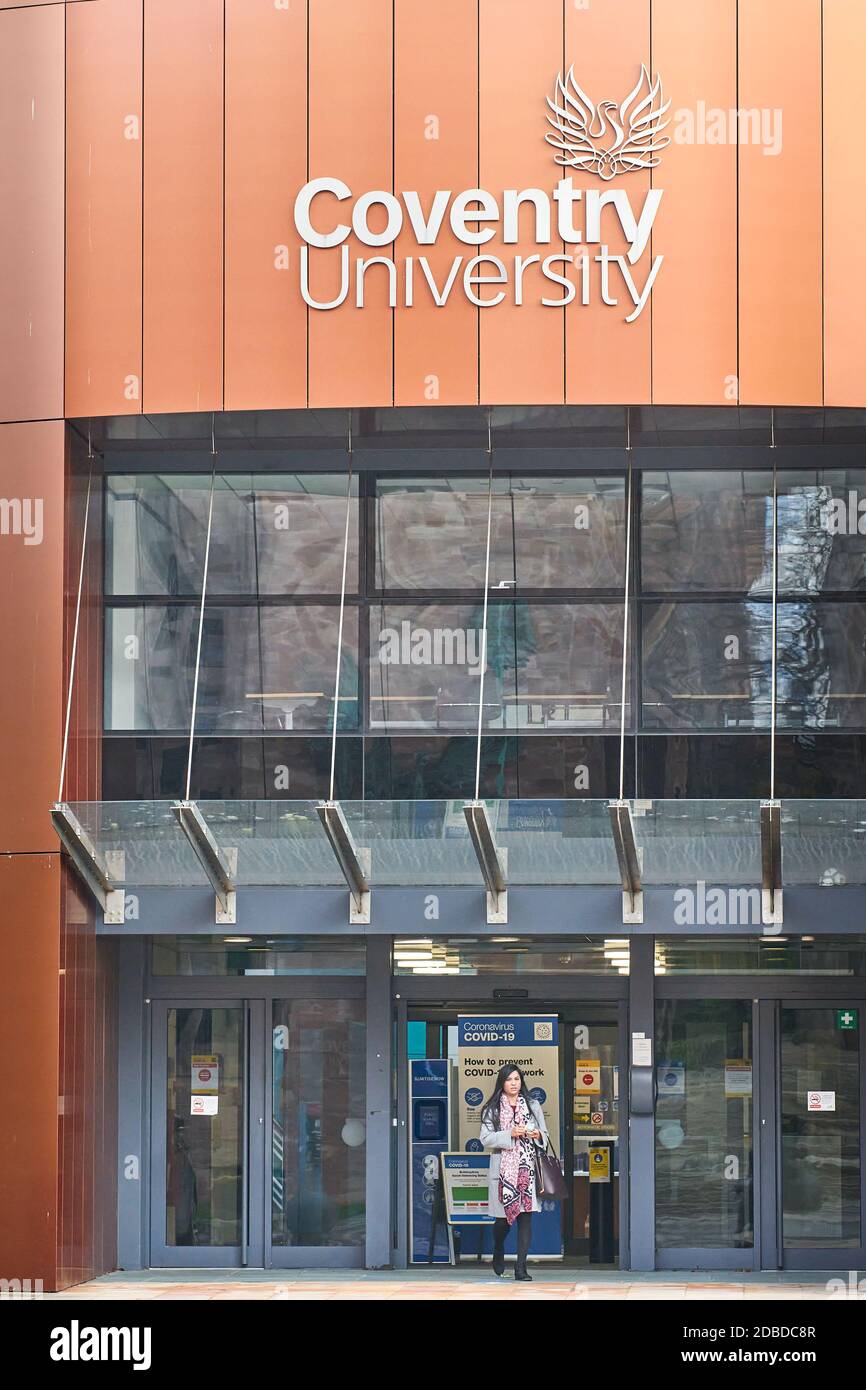 A student stands at the entrance and exit to and from the Alan Berry building (which houses the vice chancellor's office) at the university of Coventr Stock Photo