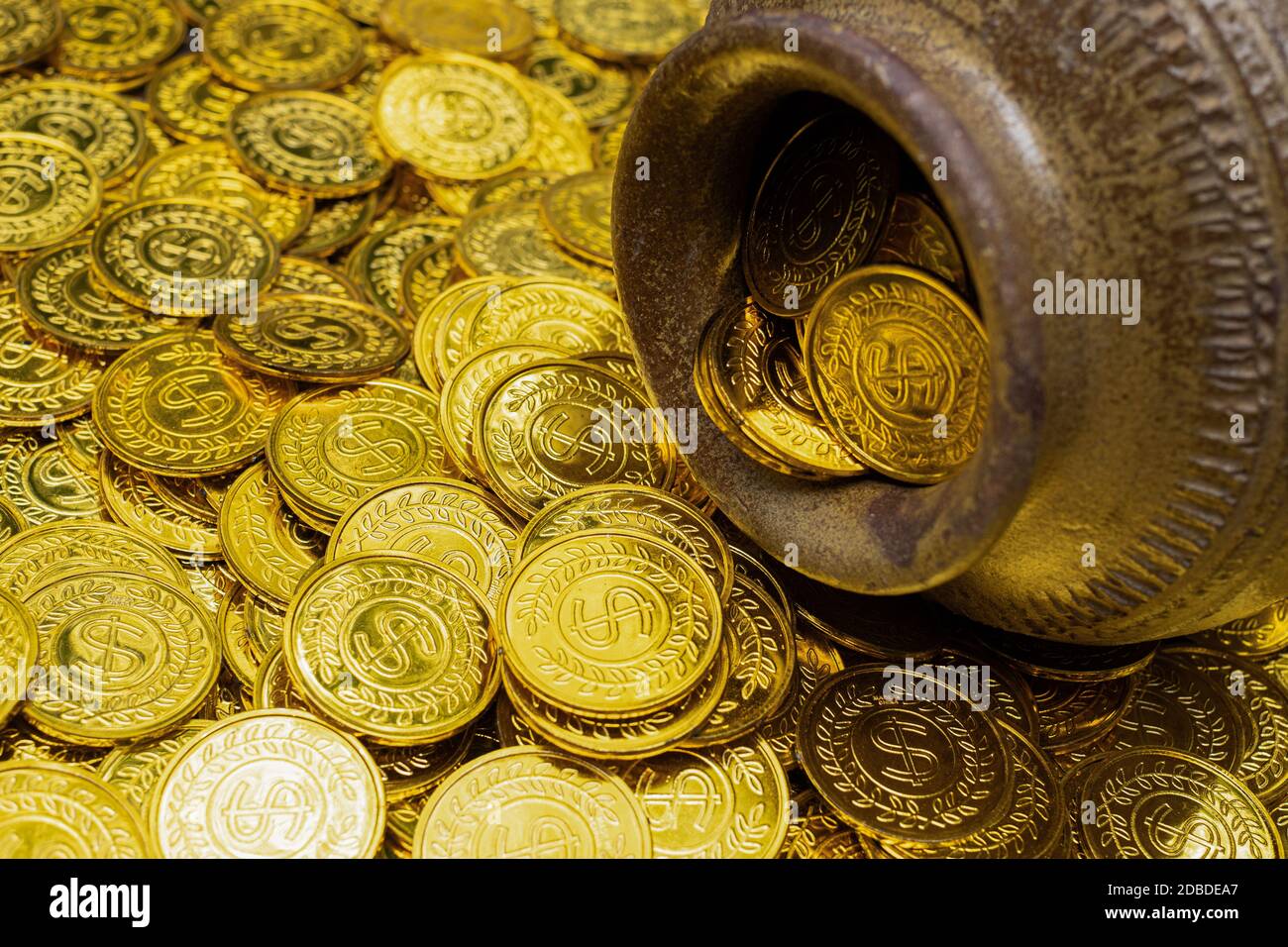 Gold coin in treasure old clay pot on a pile of gold coins Stock Photo