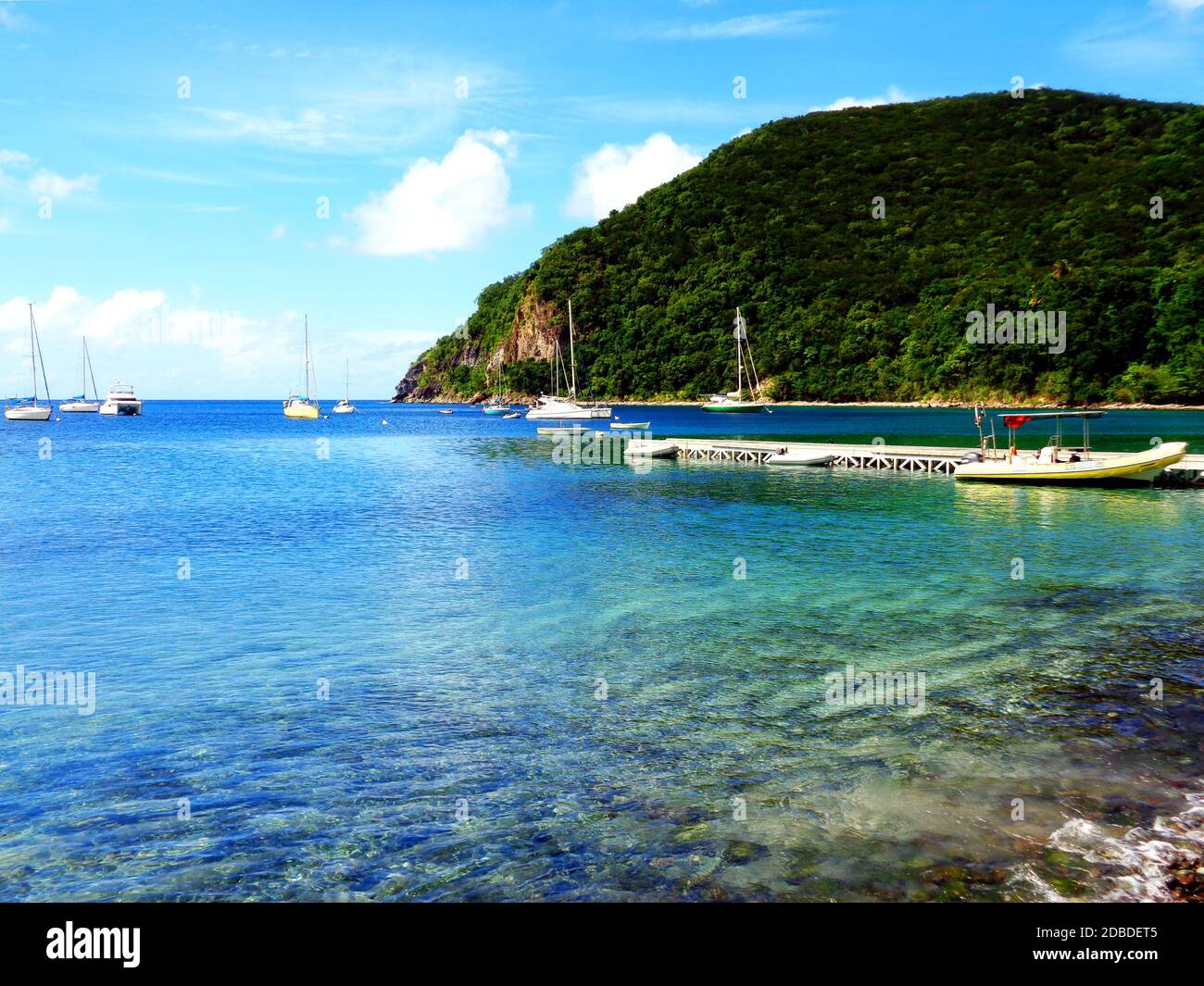 Boats anchored in the bay of Deshaies, Guadeloupe Stock Photo