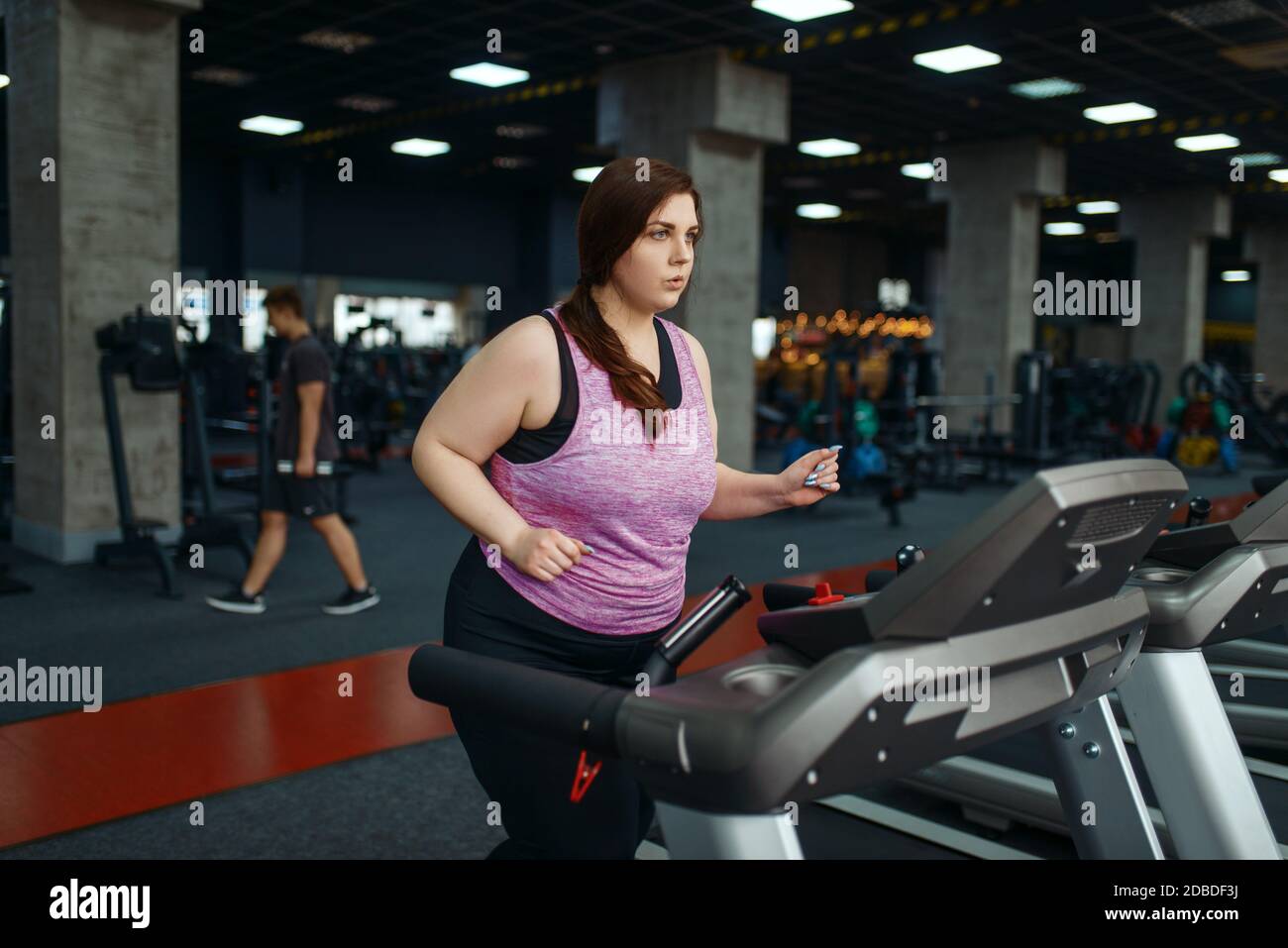 Overweight woman doing exercise on treadmill in gym active training. Obese female person struggles with excess weight aerobic workout against obesit Stock Photo Alamy