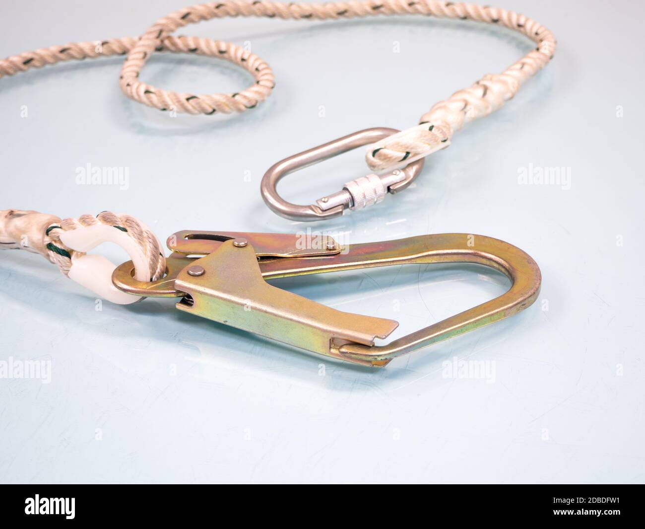 Figure eight knot with carabiner. Silver carabiner with lock andrope isolated on white background. Stock Photo