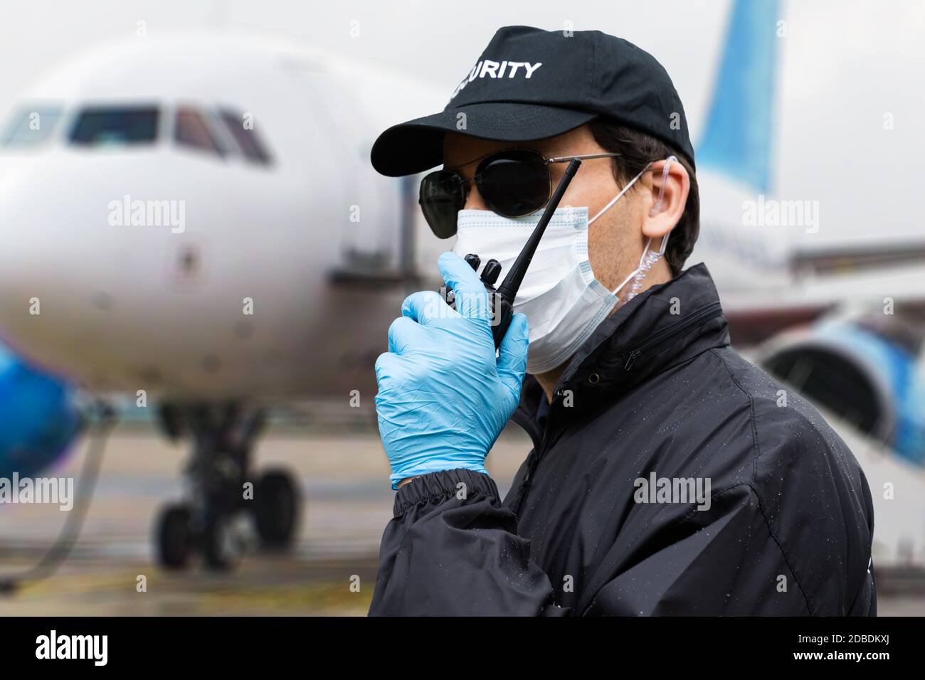 Security Guard Talking On Walkie Talkie Near Airplane Stock Photo Alamy