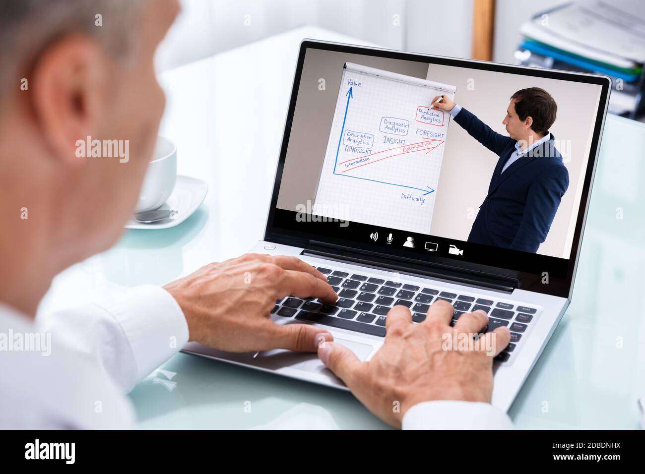 Man Participating In Online Coaching Session Using Laptop Stock Photo