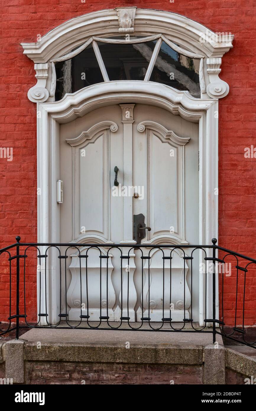 Old double door with windows in a red house Stock Photo