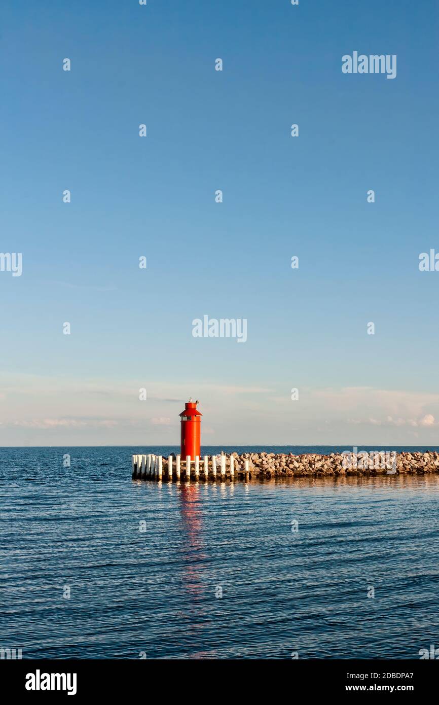 Small red lighthouse on a breakwater at Hou, Denmark Stock Photo