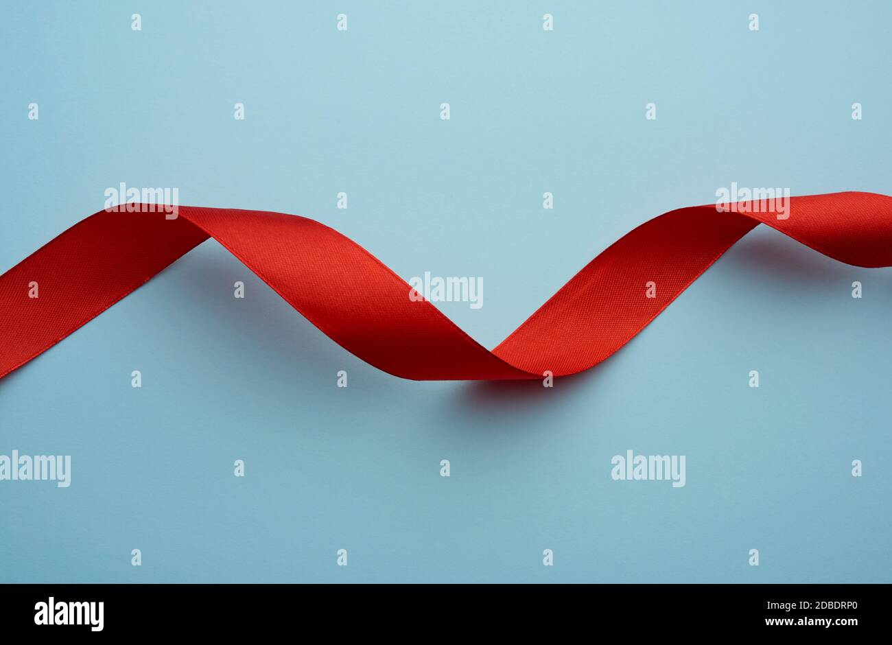 Twisted blue silk ribbon hi-res stock photography and images - Alamy
