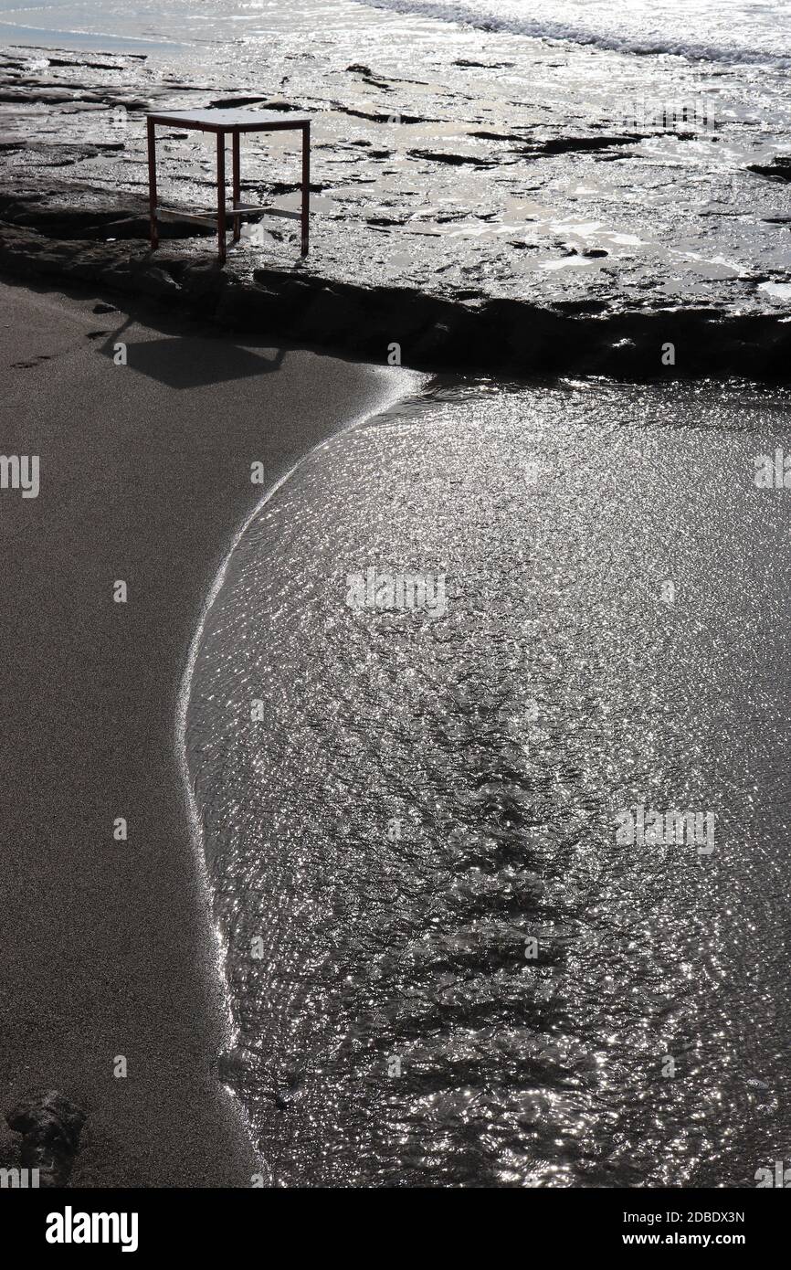 Water ripples and table on a cliff with sunlight reflection. Summer ...