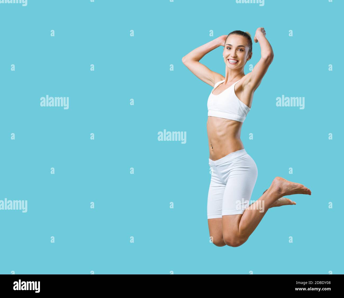 Happy fit woman jumping and smiling, weight loss and exercise concept Stock Photo