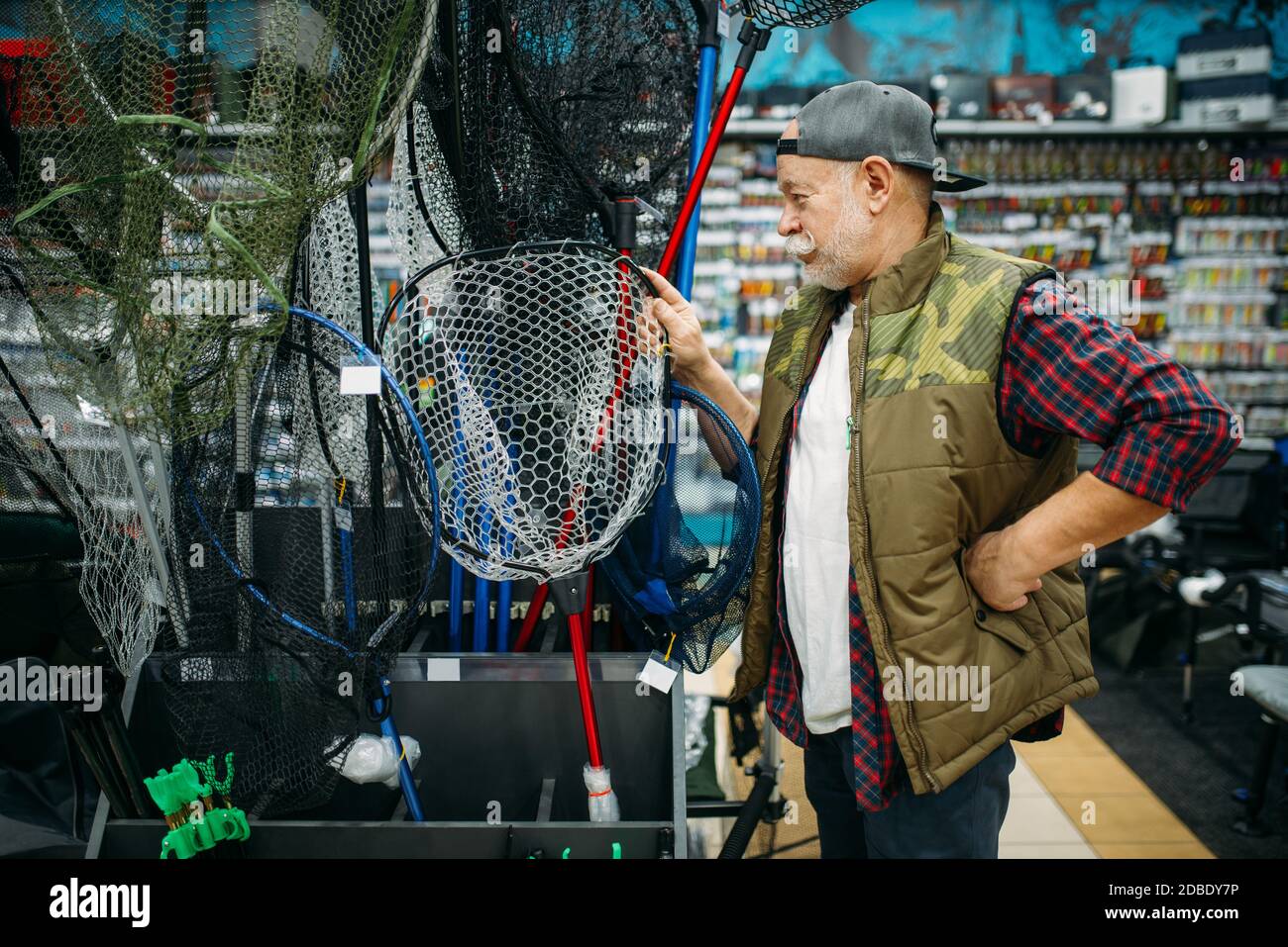 Fisherman with net and toolbox in fishing shop, hooks and baubles on  background. Equipment and tools for fish catching and hunting, accessory  choice o Stock Photo - Alamy