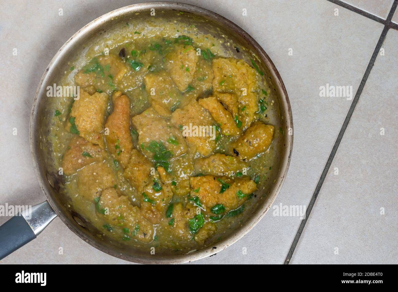 Pork rinds in green salsa, Chicharron in salsa verde, Mexican food. A