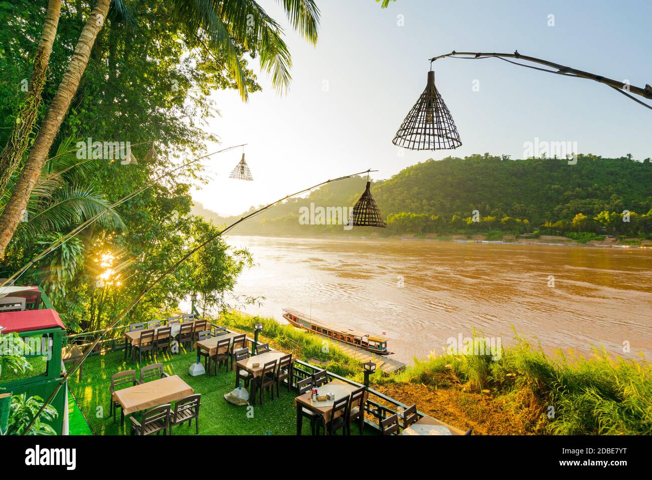 Luang Prabang, Laos - 14 Oct 2015: A restaurant terrace is overlooking the Mekong river with fishing pole lamp posts in Luang Prabang, Laos Stock Photo