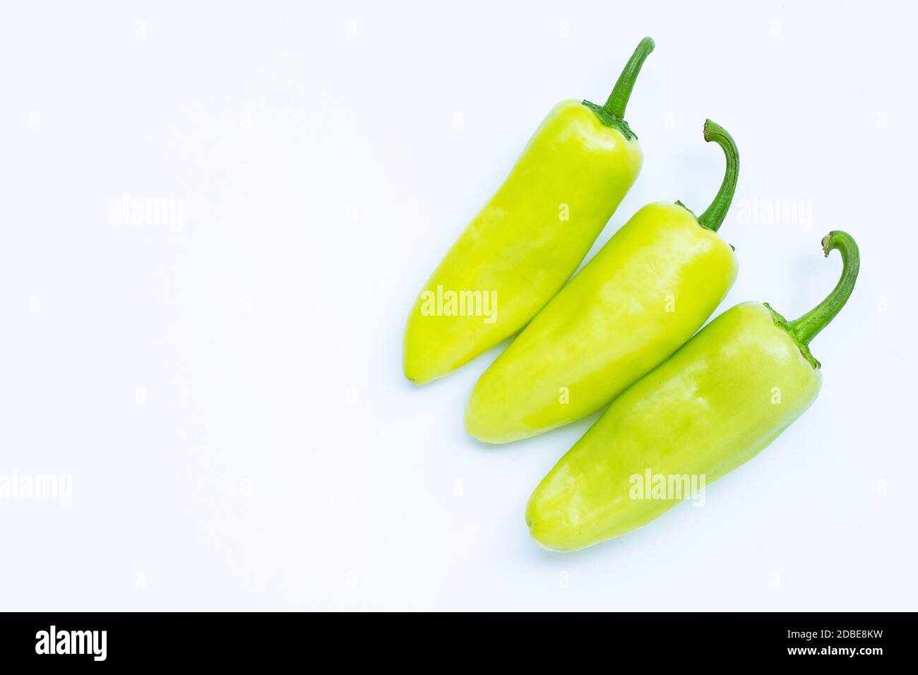 Green hot peppers on a white background Stock Photo - Alamy