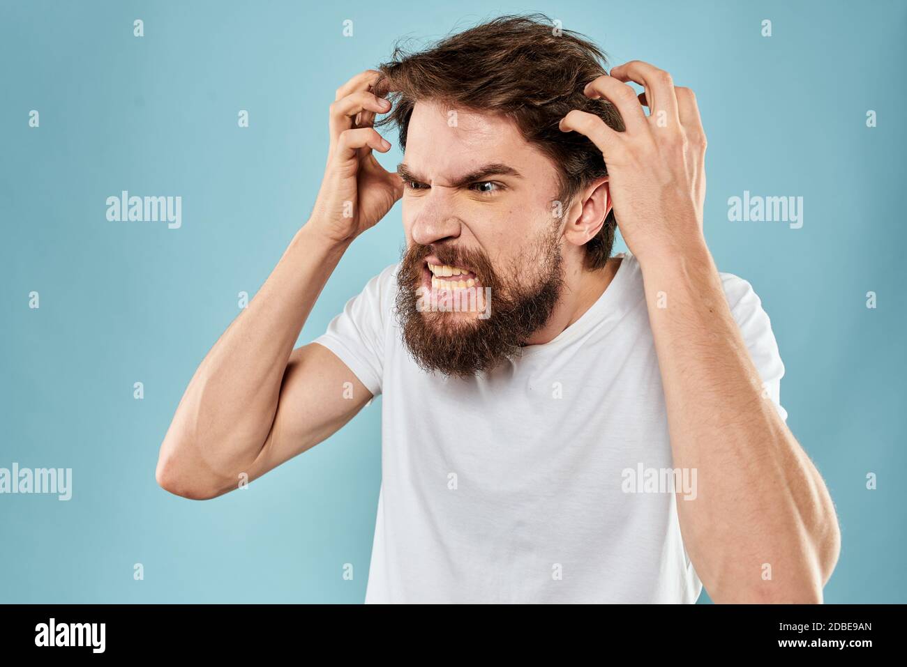 Man with disgruntled facial expression gesturing with hands studio ...