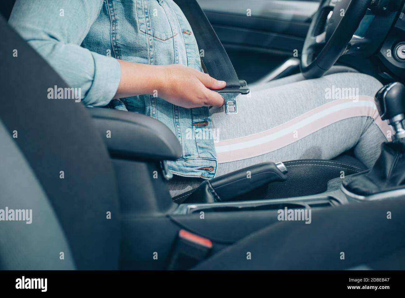 Driver woman fastening seat belt in the car, against car crash, safety concept Stock Photo