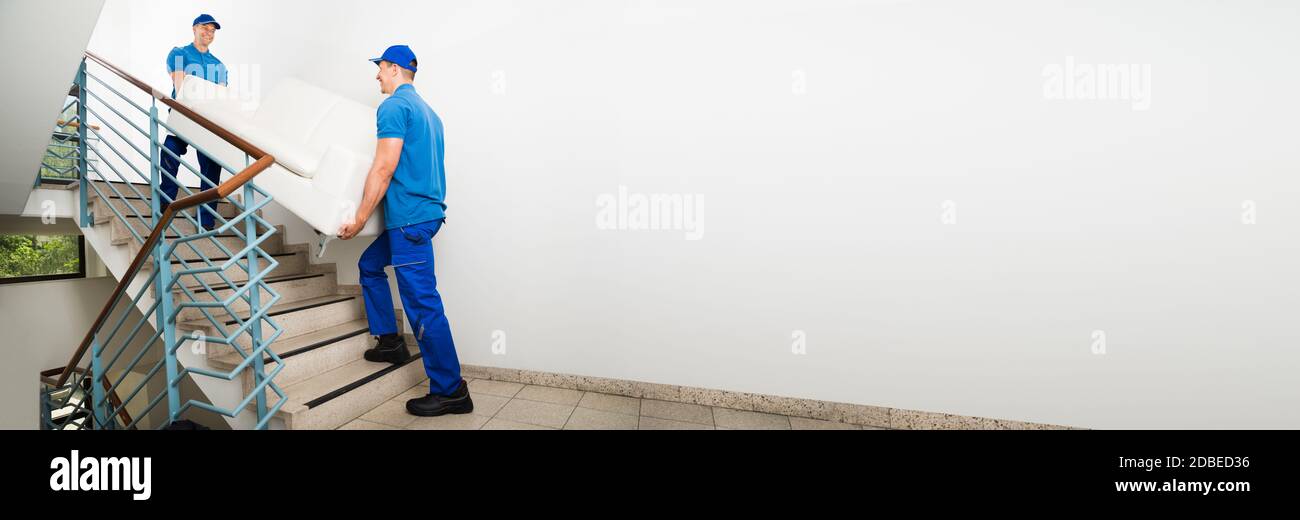 Movers Moving Furniture. Mover Men Carrying Sofa Stock Photo Alamy
