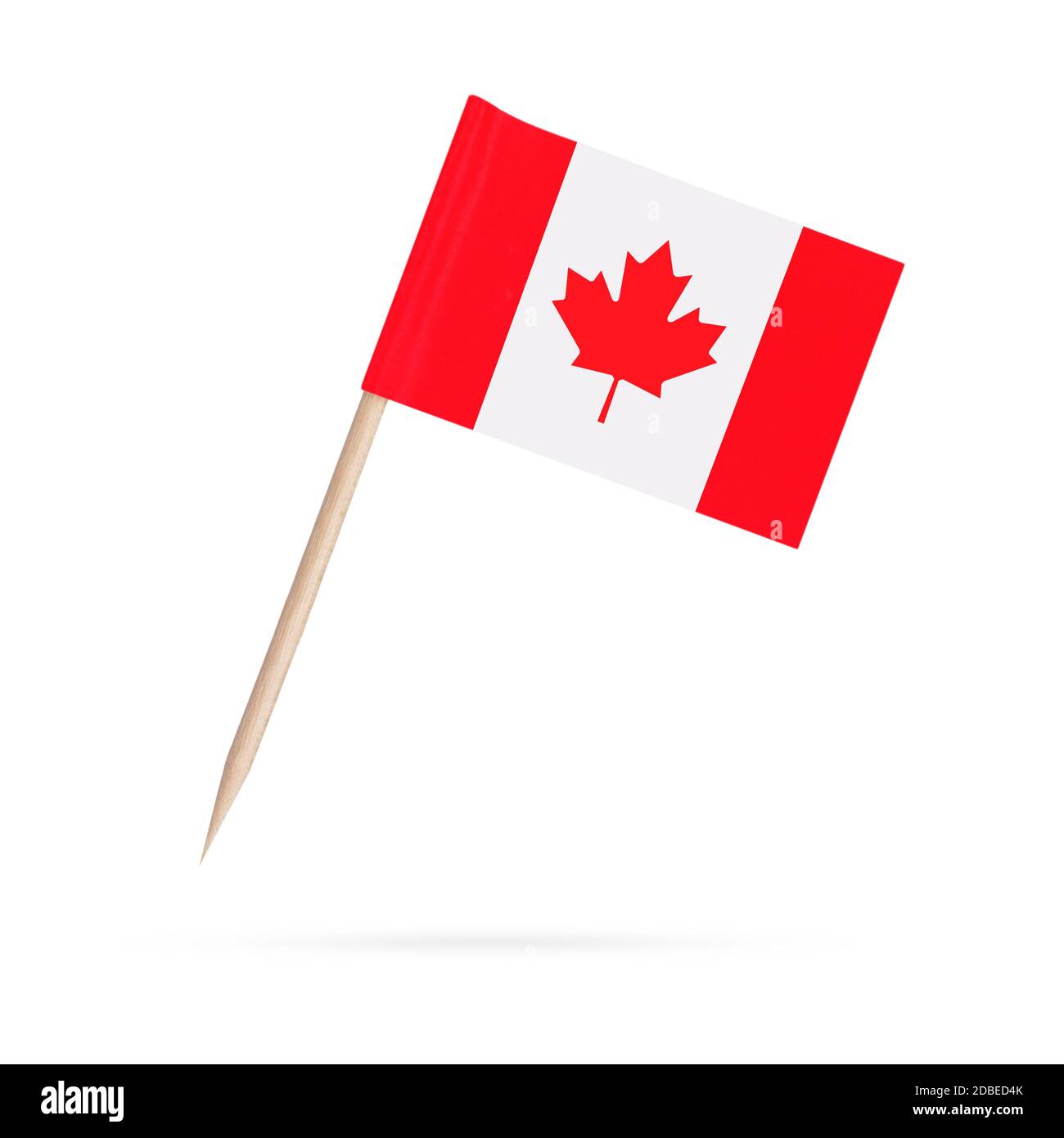 Miniature paper flag Canada. Isolated Canadian toothpick flag pointer on white background. With shadow below Stock Photo