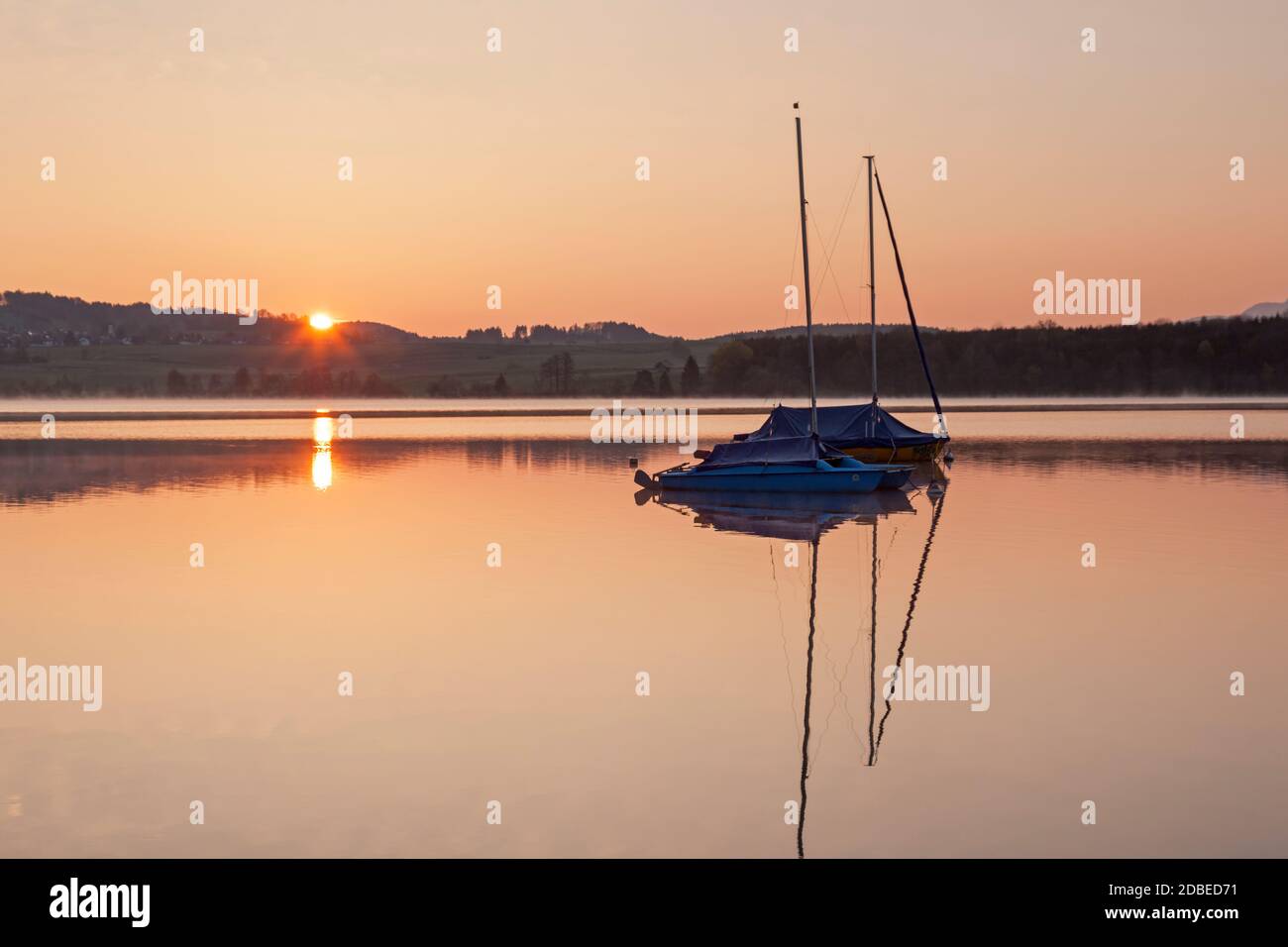 geography / travel, Germany, Bavaria, Riegsee, sailboat to the Riegsee at sunrise, Upper Bavaria, Sout, Additional-Rights-Clearance-Info-Not-Available Stock Photo