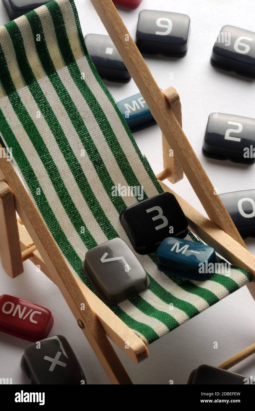 Keys of the electronic calculator on beach chair Stock Photo
