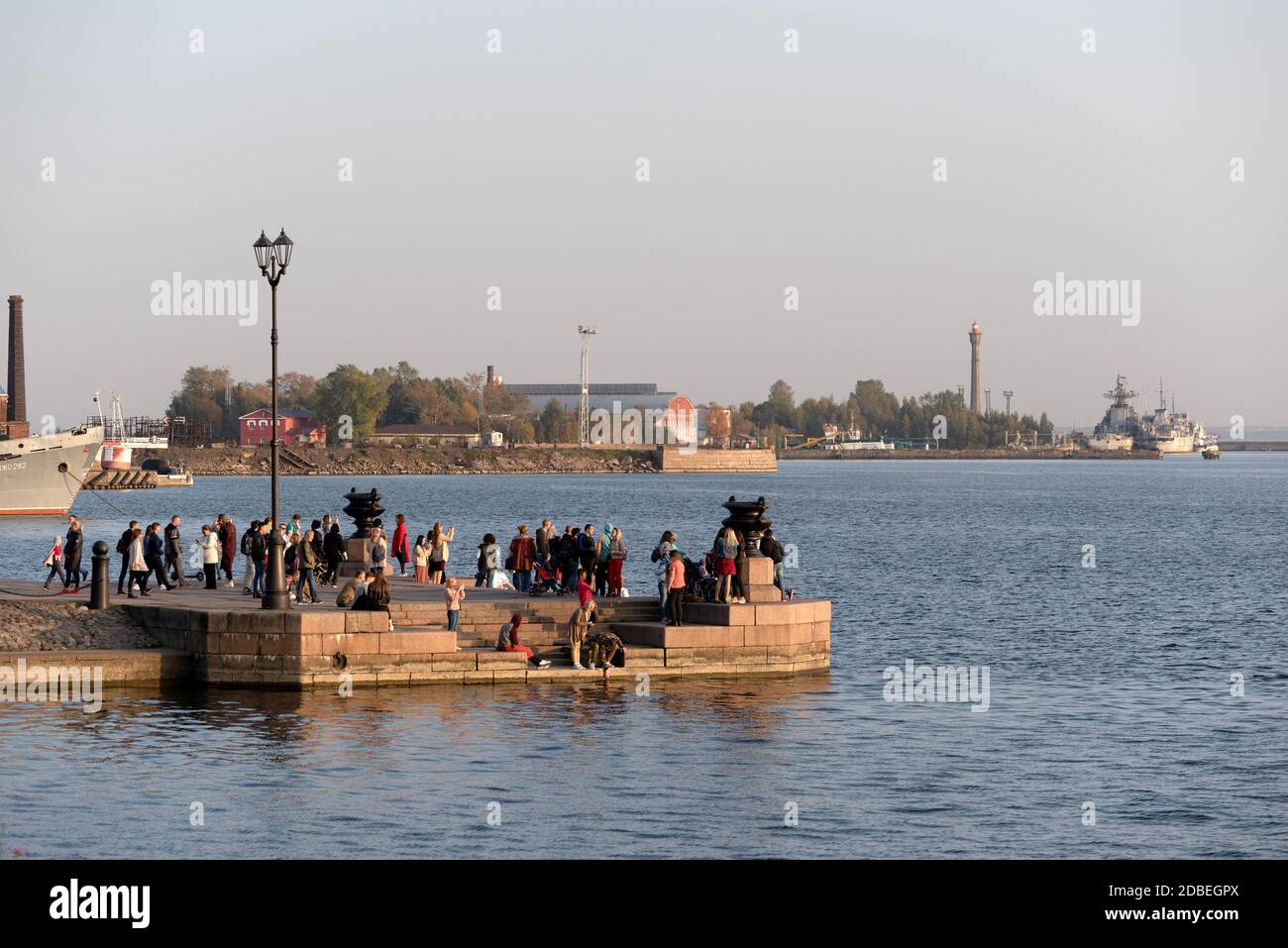 Kronstadt, Saint Petersburg, Russia — September 27, 2020: People look at the bay and take photographs at The Petrovskaya pier Stock Photo