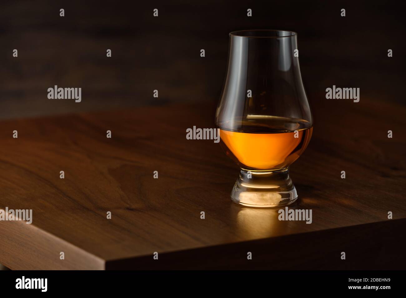 Glencairn glass with scottisch single malt whisky on wooden taböe Stock Photo