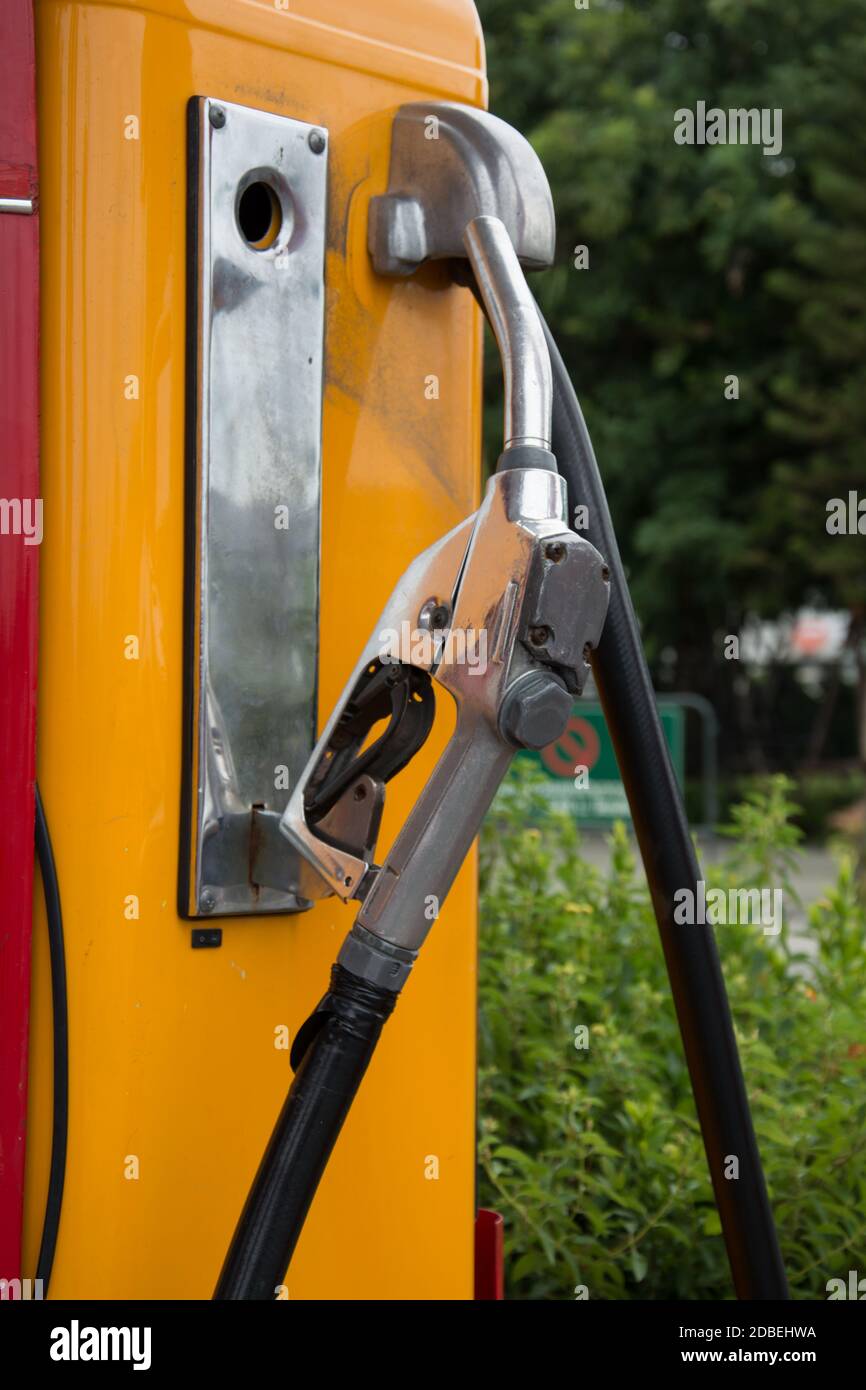 the Gas pump nozzles in the retro service station, vintage color tone