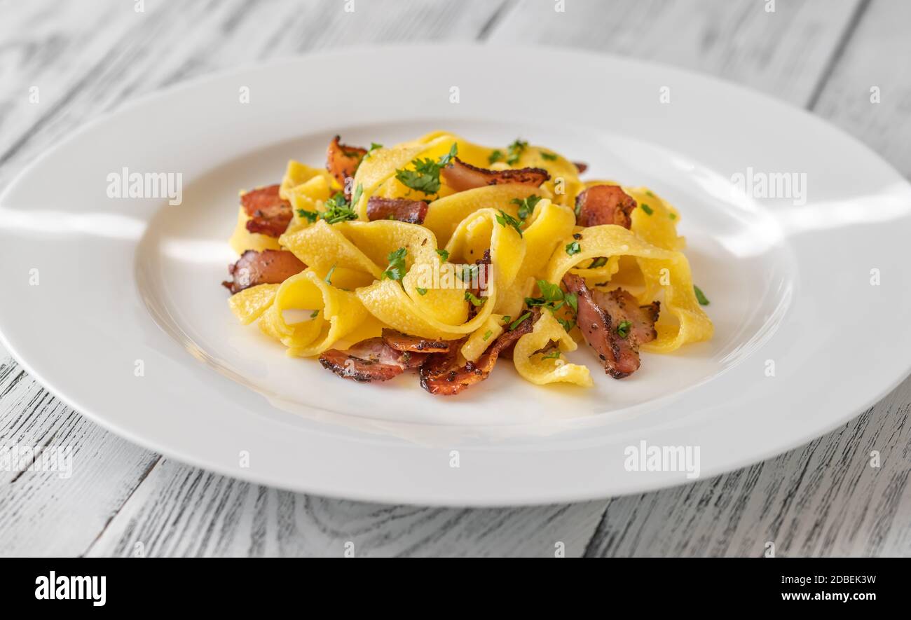 Pappardelle pasta with pancetta. Variation of Carbonara pasta Stock ...