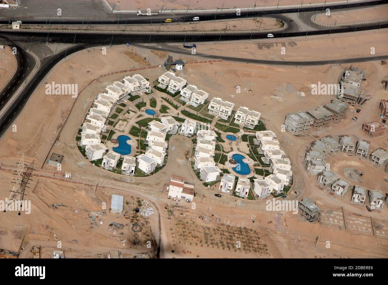 View of Egyptian resorts with swimming pools from plane. Tropical resorts, aerial view. Ranorama earth objects from air. Desert, oasis, pools and tour Stock Photo