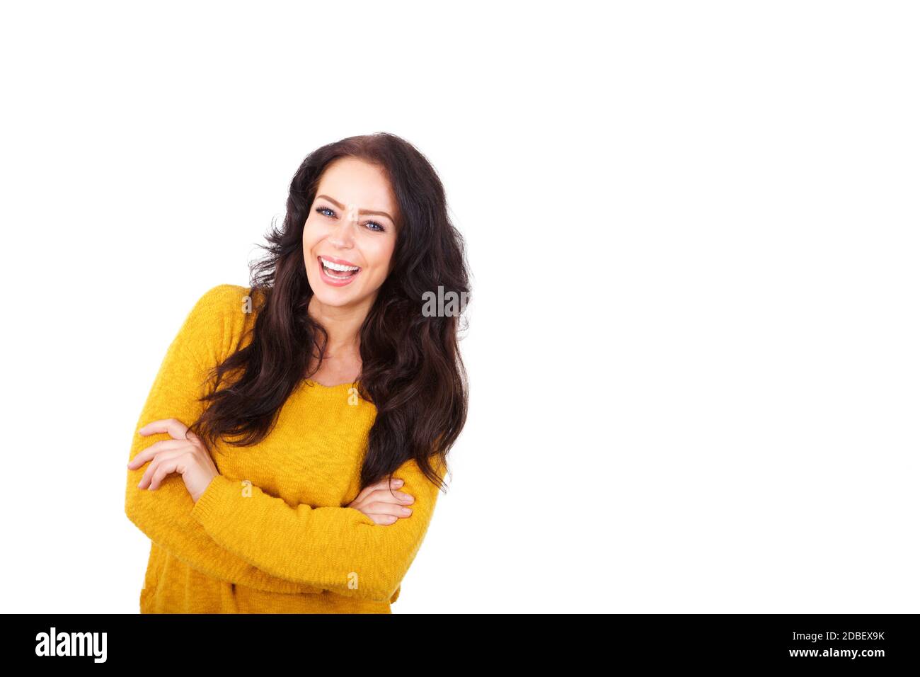 Portrait of attractive older woman laughing with arms crossed Stock Photo