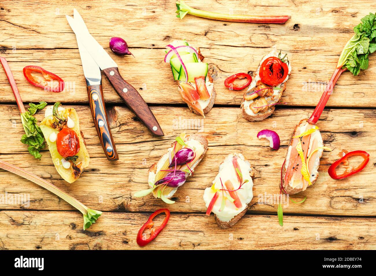 Tasty italian bruschetta with vegetables and ingredients.Assorted different bruschetta on a wooden table Stock Photo