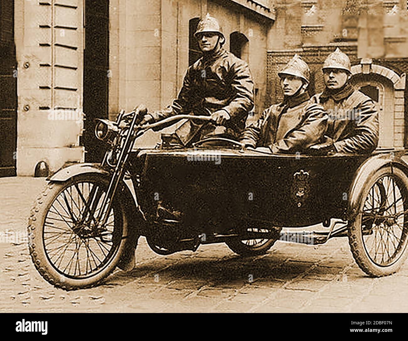 An ear;y French photograph of a Paris firecrew motorcycle andf sidecar with three firemen Stock Photo