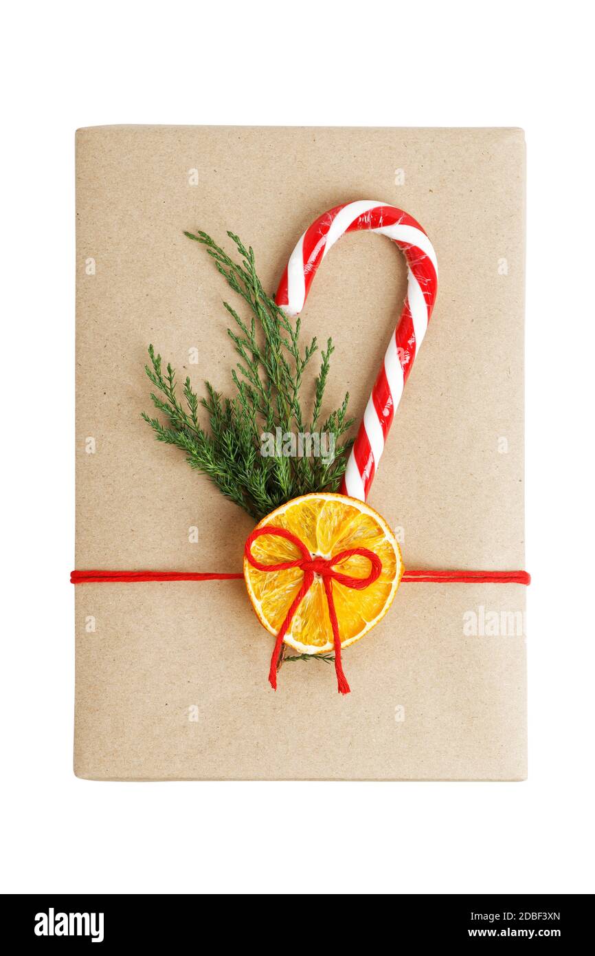 Gift box wrapped in kraft paper, tied with red twine and decorated with ...