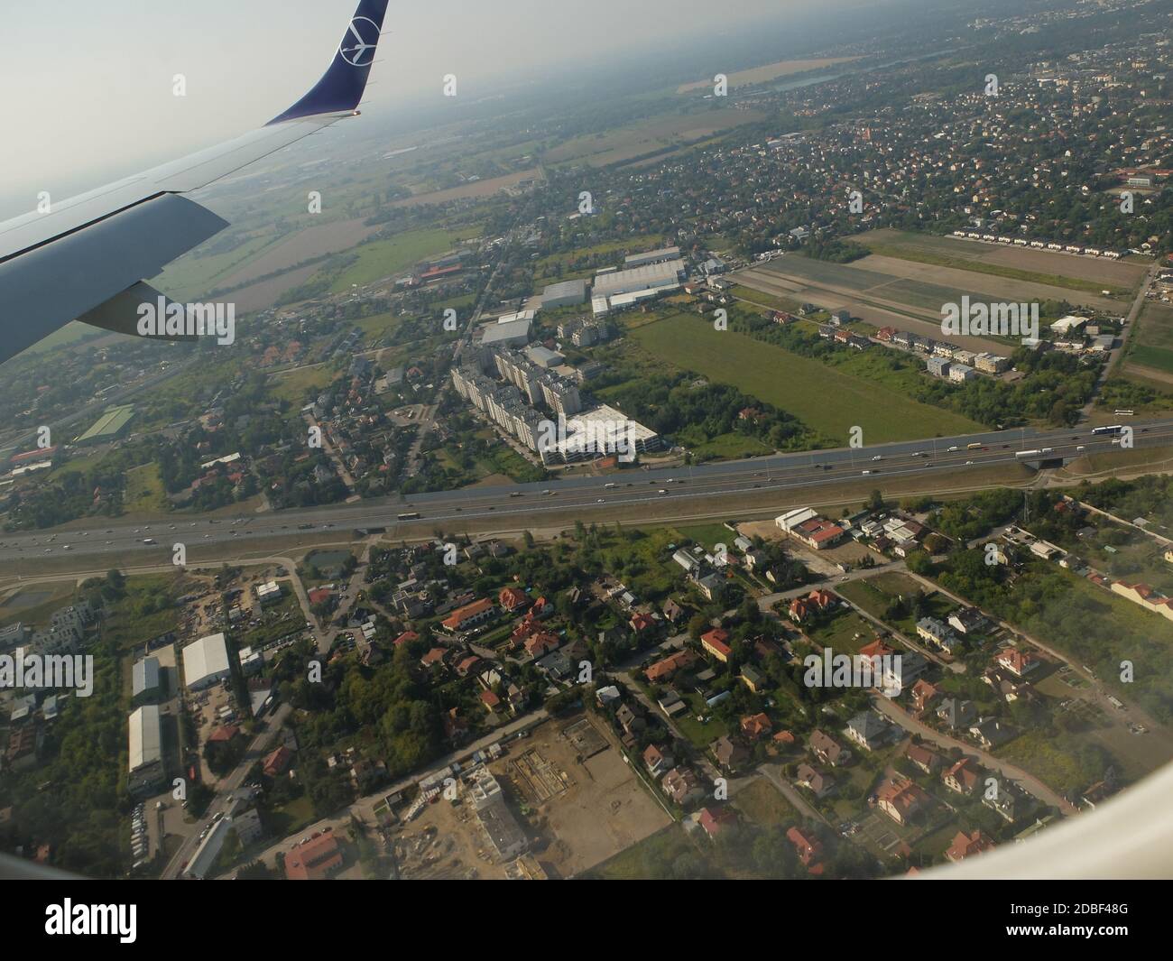 LOT Airlines B737-800 flight from London Heathrow to Warsaw,Poland approaches Chopin Airport,Warsaw as viewed from right hand passenger cabin window o Stock Photo