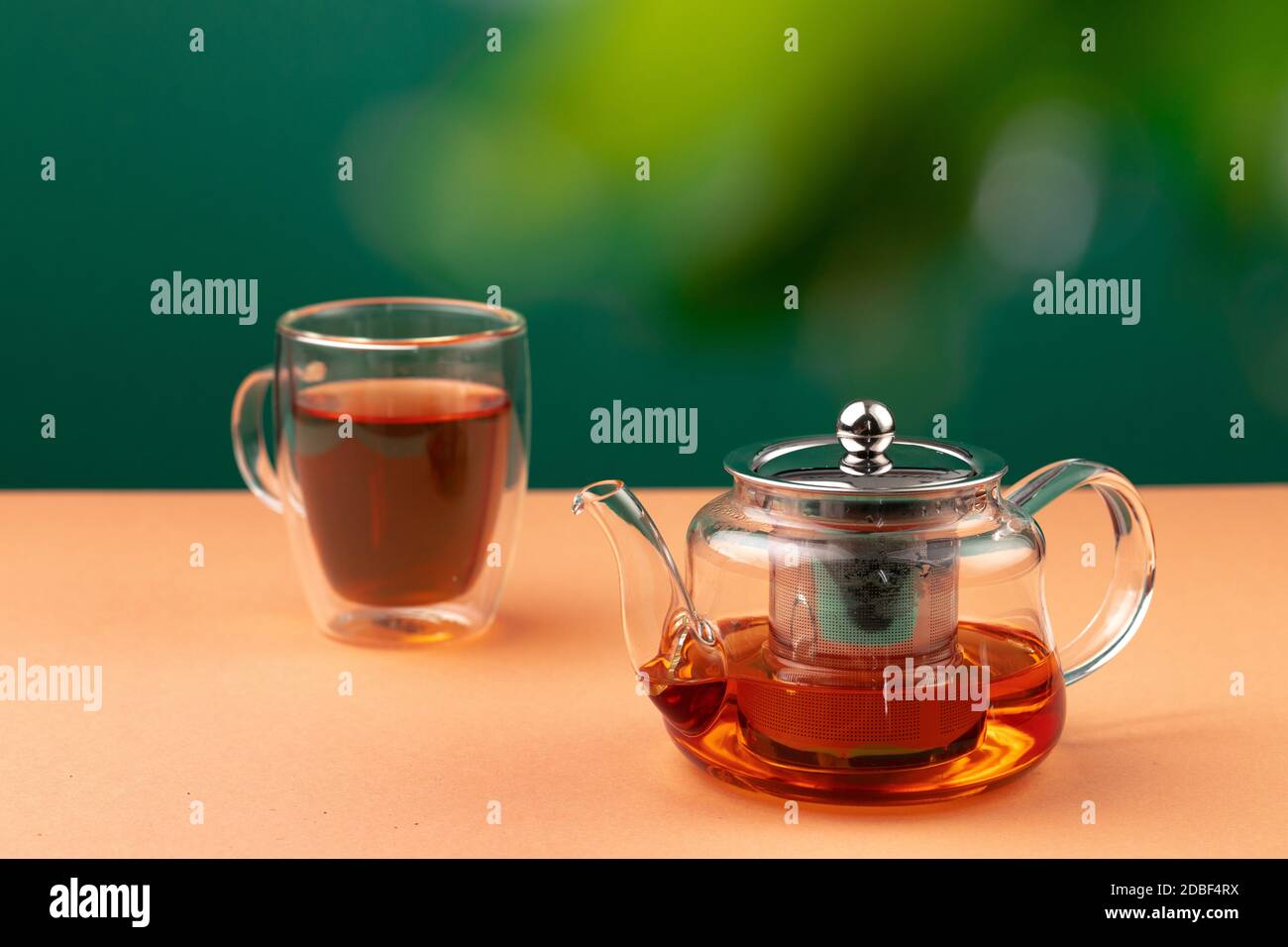 Glass teapot and cup with black tea Stock Photo - Alamy
