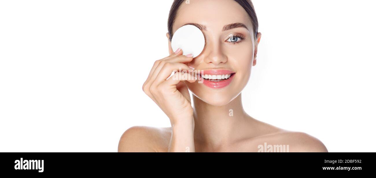 Makeup remove, skin care. Smiling woman with cosmetic cotton pad near her face, concept remove makeup and clean skin Stock Photo